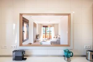 a mirror over a sink in a bathroom at Serena Golf Apartments in Los Alcázares