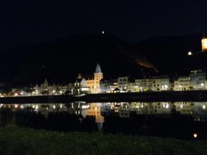 a city at night with its reflection in the water at Moselfrische in Zell an der Mosel