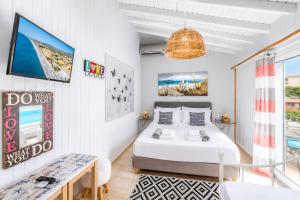 a bedroom with a bed and a table at Beach House Cavo Kiotari in Gennadi +20 photos