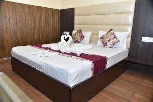 a bedroom with a bed with white towels on it at Hotel 4G in Bhopal