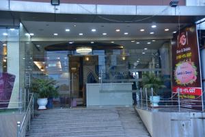 a entrance to a building with stairs and potted plants at Hotel 4G in Bhopal +16 photos