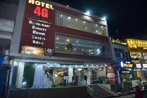 a hotel at night with people standing outside of it at Hotel 4G in Bhopal