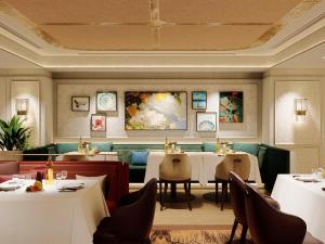 a restaurant with tables and chairs in a room at The St. Regis Jakarta in Jakarta