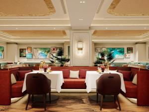 a restaurant with two tables and a red couch at The St. Regis Jakarta in Jakarta