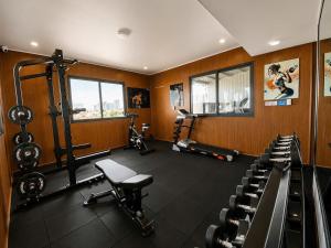 a room with a gym with tread machines and chairs at Thảo Ngân Pleiku Hotel in Pleiku +25 photos