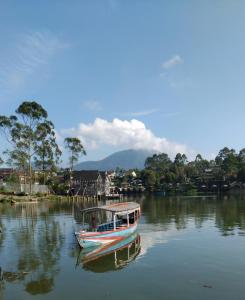 a boat is docked on a body of water at Banyu 1 in Palayangan