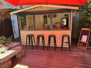 a set of three bar stools on a deck at LA MAISON JEROBOAM in Saint-Estèphe