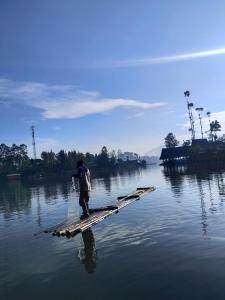a man standing on a raft in the water at Banyu 1 in Palayangan