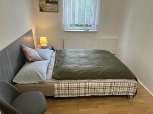 a bed in a small room with a window at FLC Rooms in Rødby +18 photos