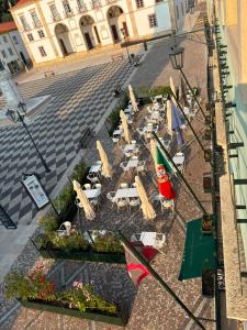 a group of chairs and tables with umbrellas on a street at Hotel República Boutique Hotel in Tomar