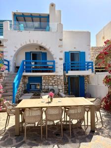 a table and chairs in front of a building at Paros Home in Kampos Paros