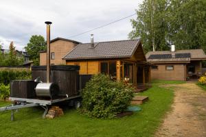 a house with a truck parked in front of it at Unique Mailo House & Cottage in Riga