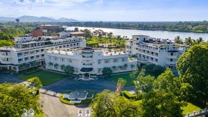 an aerial view of a large white building next to a river at Azerai La Residence, Hue in Hue