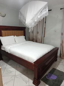 a bed with a canopy in a room at J & J Olosho Hotel in Kiserian