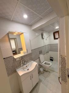 a bathroom with a sink and a toilet at Deluxe apart in Pamukkale +8 photos