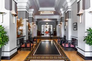 a lobby with chairs and a pool in the middle at Azerai La Residence, Hue in Hue +175 photos