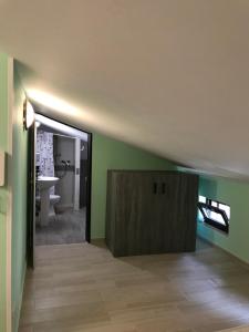 a bathroom with green walls and a wooden cabinet at Casa Vacanza Finalmente in SantʼAngelo le Fratte +43 photos