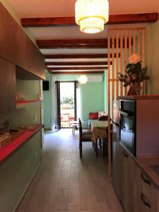 a kitchen with a table and a dining room at Casa Vacanza Finalmente in SantʼAngelo le Fratte