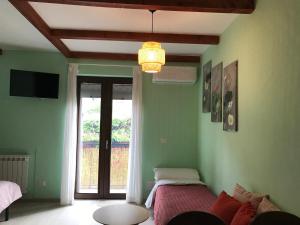 a bedroom with two beds and a chandelier at Casa Vacanza Finalmente in SantʼAngelo le Fratte