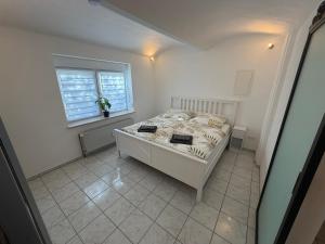 a bedroom with a bed and a window at Auszeit am Brunnen in Mendig
