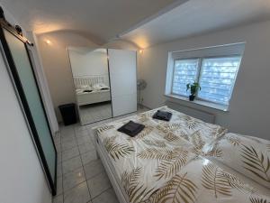 a bedroom with a large bed and a mirror at Auszeit am Brunnen in Mendig