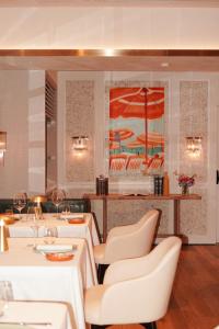 a dining room with white tables and chairs at The St. Regis Jakarta in Jakarta +87 photos