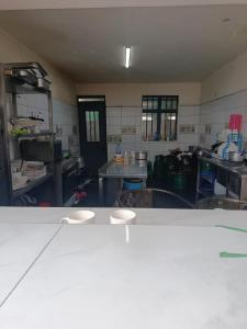 a kitchen with tables and chairs in a room at J & J Olosho Hotel in Kiserian