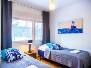 Postel nebo postele na pokoji v ubytování Haapala Suites entinen IIDA Vuokatti