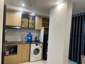 a kitchen with a sink and a washing machine at Tâm An Luxury Hotel in Ninh Lão