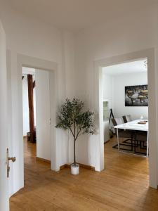 a living room with a table and a potted tree at Foundry ONE LoftQuartier in Jugenstilvilla in Wittlich