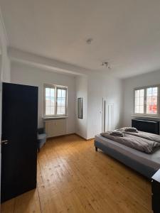 a large bedroom with a bed and a wooden floor at Foundry ONE LoftQuartier in Jugenstilvilla in Wittlich
