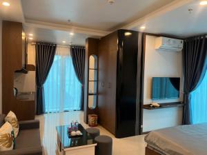 a bedroom with a bed and a living room at Tâm An Luxury Hotel in Ninh Lão