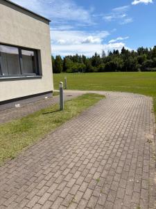 a brick walkway in front of a building at Kambarių nuoma in Utena