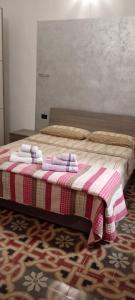 a bedroom with a bed with towels on it at B&B Casa dolce casa in Cutrofiano