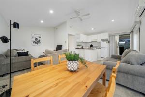 a kitchen and living room with a wooden table at Relax and Rejuvenate in Vermont