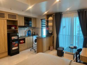 a room with a kitchen and a living room with a bed at Tâm An Luxury Hotel in Ninh Lão