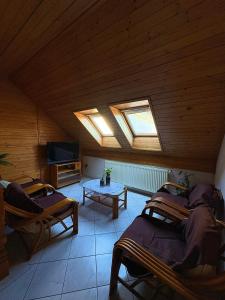 a attic room with two beds and a tv at Hostinec U Havlů in Olomouc