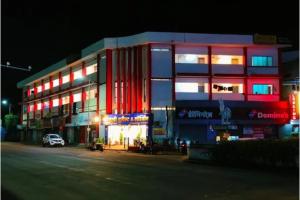 a building with red and blue lights on it at FabHotel Bhagyashri Executive in Nashik