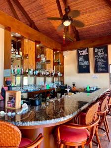 a bar in a restaurant with chairs around it at Infinity Sands Resort in Siquijor