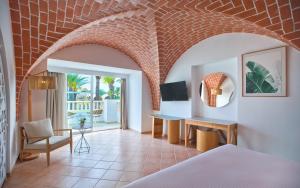 a room with a bed and a desk and a chair at Steigenberger Marhaba Thalasso Hammamet in Hammamet