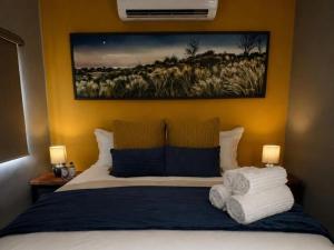 a bedroom with a bed with towels on it at Kairos Guesthouse in Thabazimbi