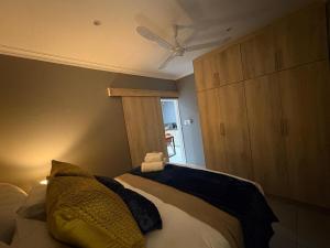 a bedroom with a bed with a ceiling fan at Kairos Guesthouse in Thabazimbi +7 photos