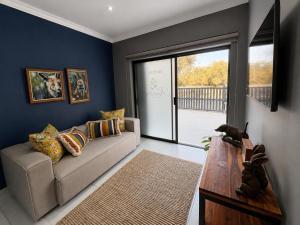 a living room with a couch and a table at Kairos Guesthouse in Thabazimbi