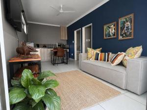 a living room with a couch and a table at Kairos Guesthouse in Thabazimbi