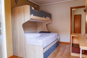 a bunk bed in a small room with a staircase at Beachfront chalet in Valencia in Valencia