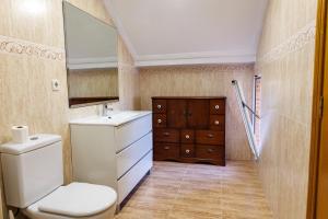 a bathroom with a toilet and a sink and a mirror at Beachfront chalet in Valencia in Valencia +58 photos