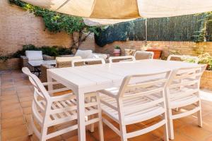 a white table and chairs on a patio at Beachfront chalet in Valencia in Valencia