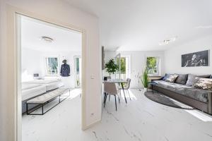 a living room with a couch and a table at Design Apartment Leipzig Airport DHL Amazon Voll ausgestattet Free Parking in Schkeuditz