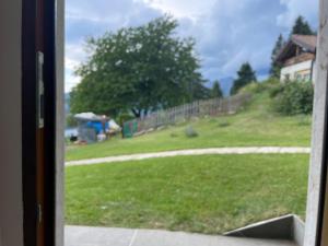 a view of a yard from a window of a house at Alpèa in Lavarone
