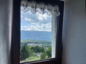 a window with a view of a mountain at Alpèa in Lavarone